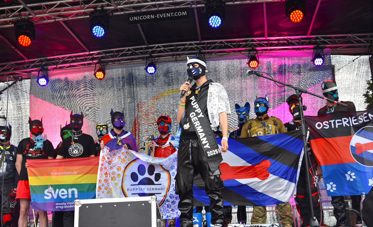 Pupplay community on stage with flags